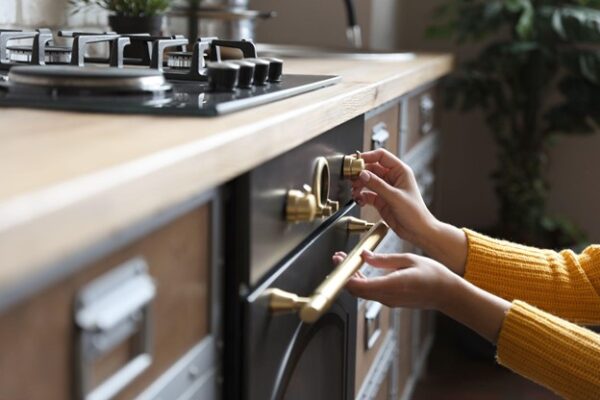 Woman Turns Down Gas on Oven