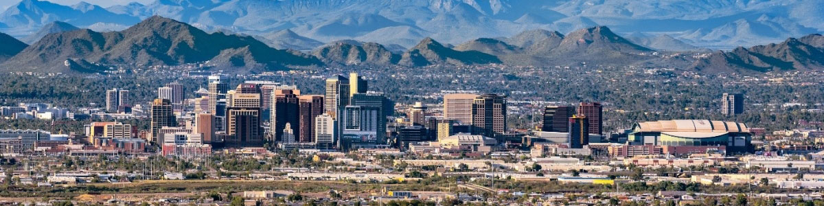 The skyscrapers of Phoenix, Arizona beneath a cloud-filled sky.